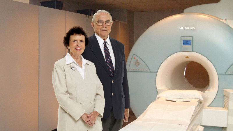 Beverly and James Thompson standing in front medical imaging equipment