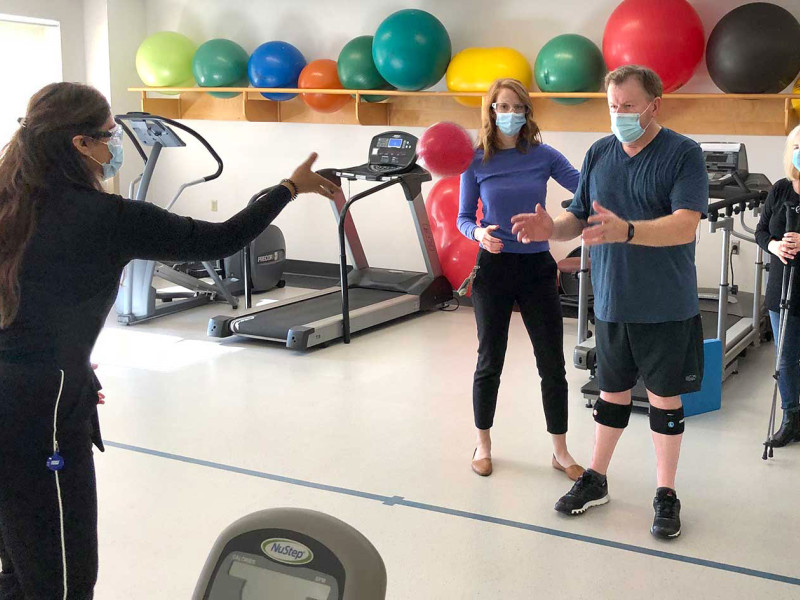 Paul Garrett participating in therapy by catching a ball thrown by a physiotherapist