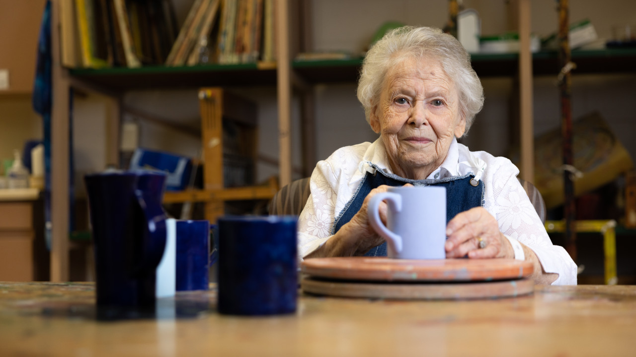 Helen smiles with her pottery project