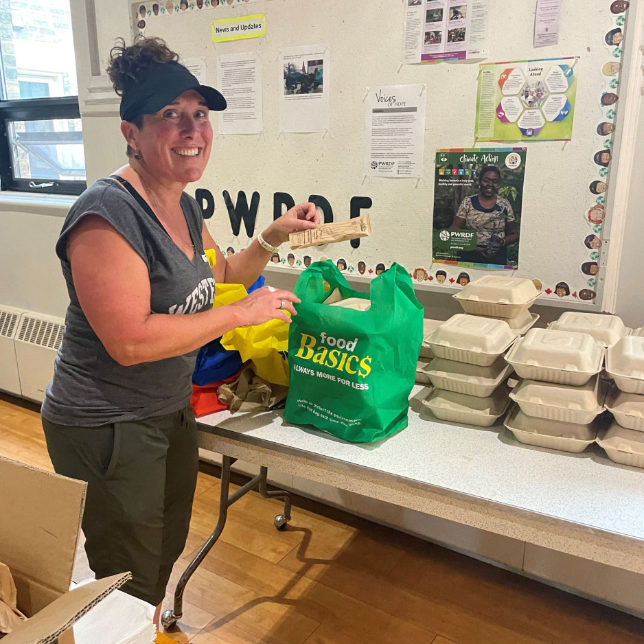 Jennifer Devlin puts groceries into a bag