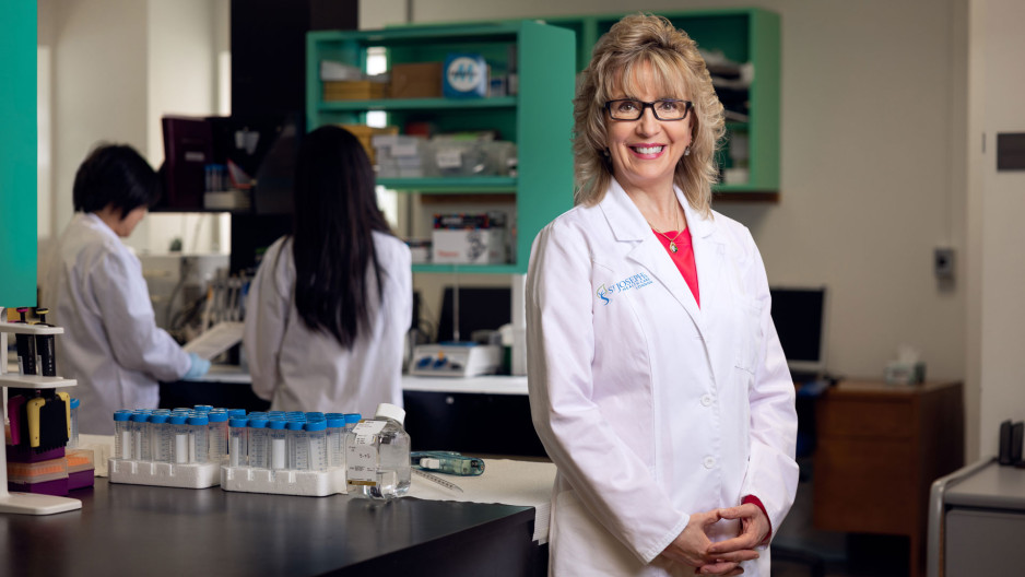 Dr. Cindy Hutnik in a laboratory with research assistants in lab coats