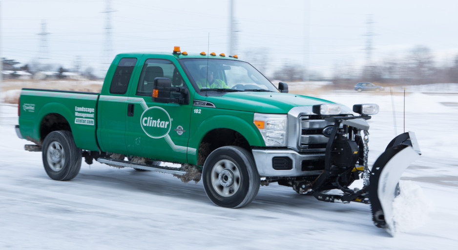 Clintar truck with a snow plow attached