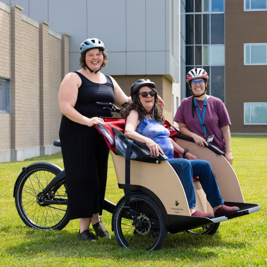 A patient and two recreational therapists sitting in a triobike