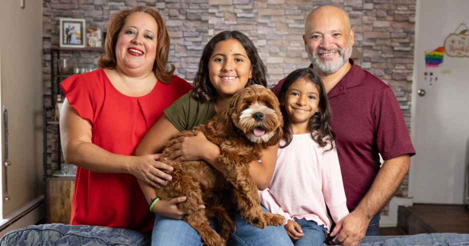 Fressia and family smiling at camera