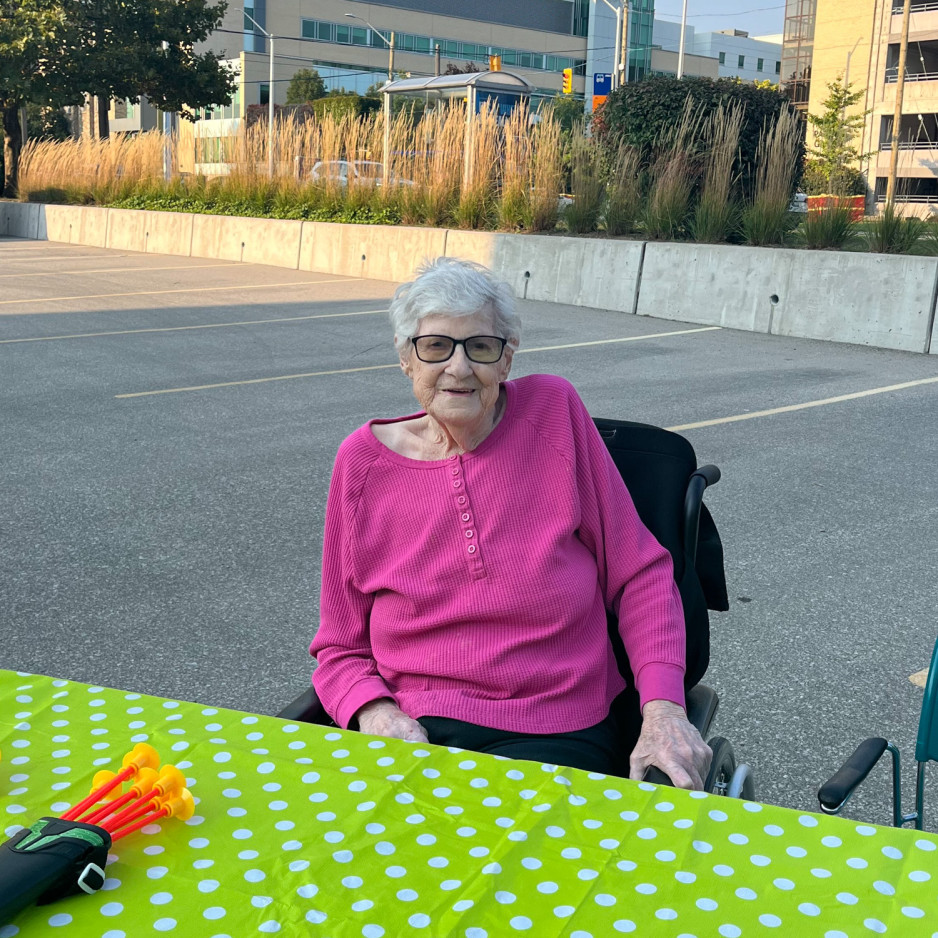 Pam Vanwyk sitting down at a table in the Mount Hope parking lot