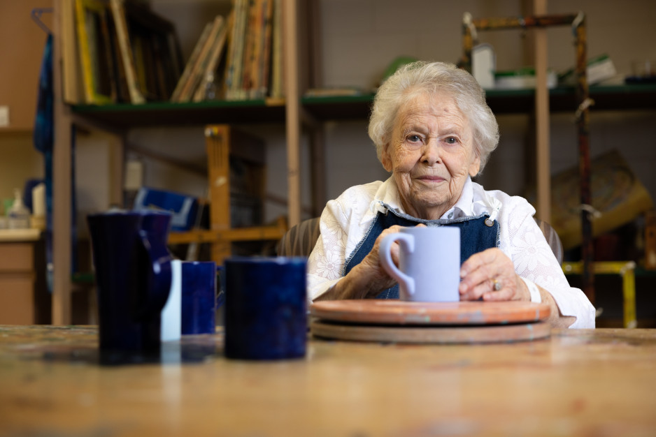 Helen smiles with her pottery project