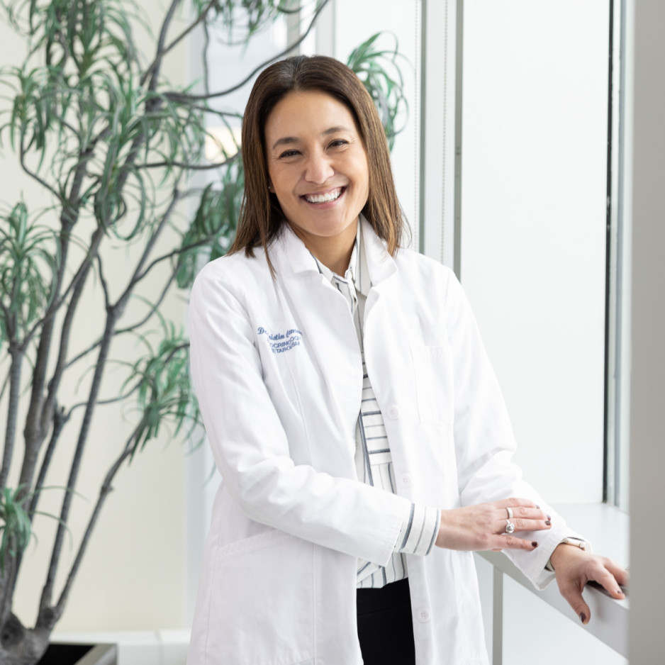 Dr. Kristin Clemens leaning against a window