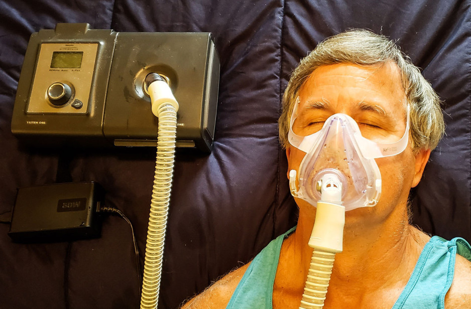 a man using his CPAP machine.