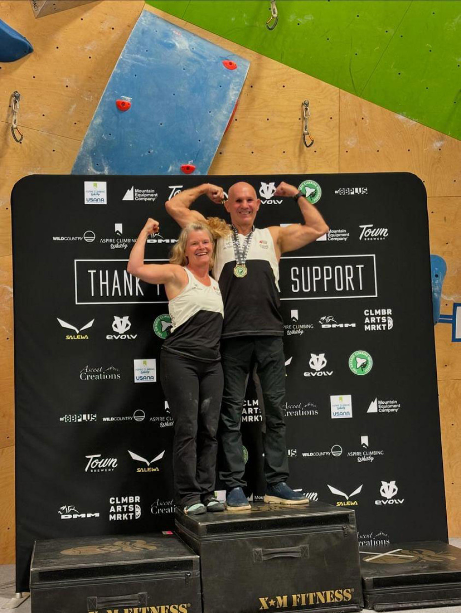 Terry and Patti on podium after Terry wins gold during the Ontario Climbing Federation competition in Nov. 2024 in Whitby, Ontario.