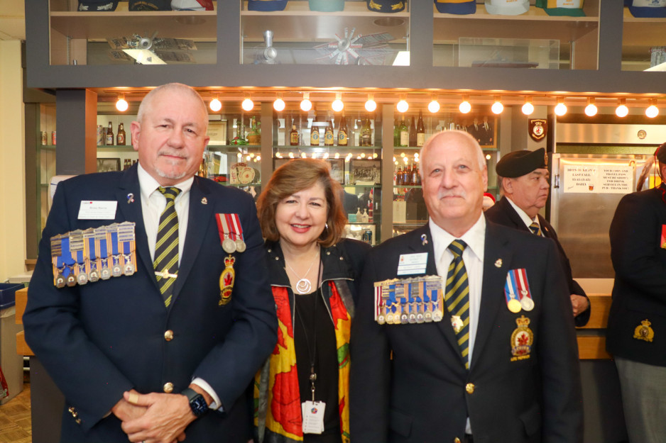 Two members of the Legion pose with Michelle Campbell