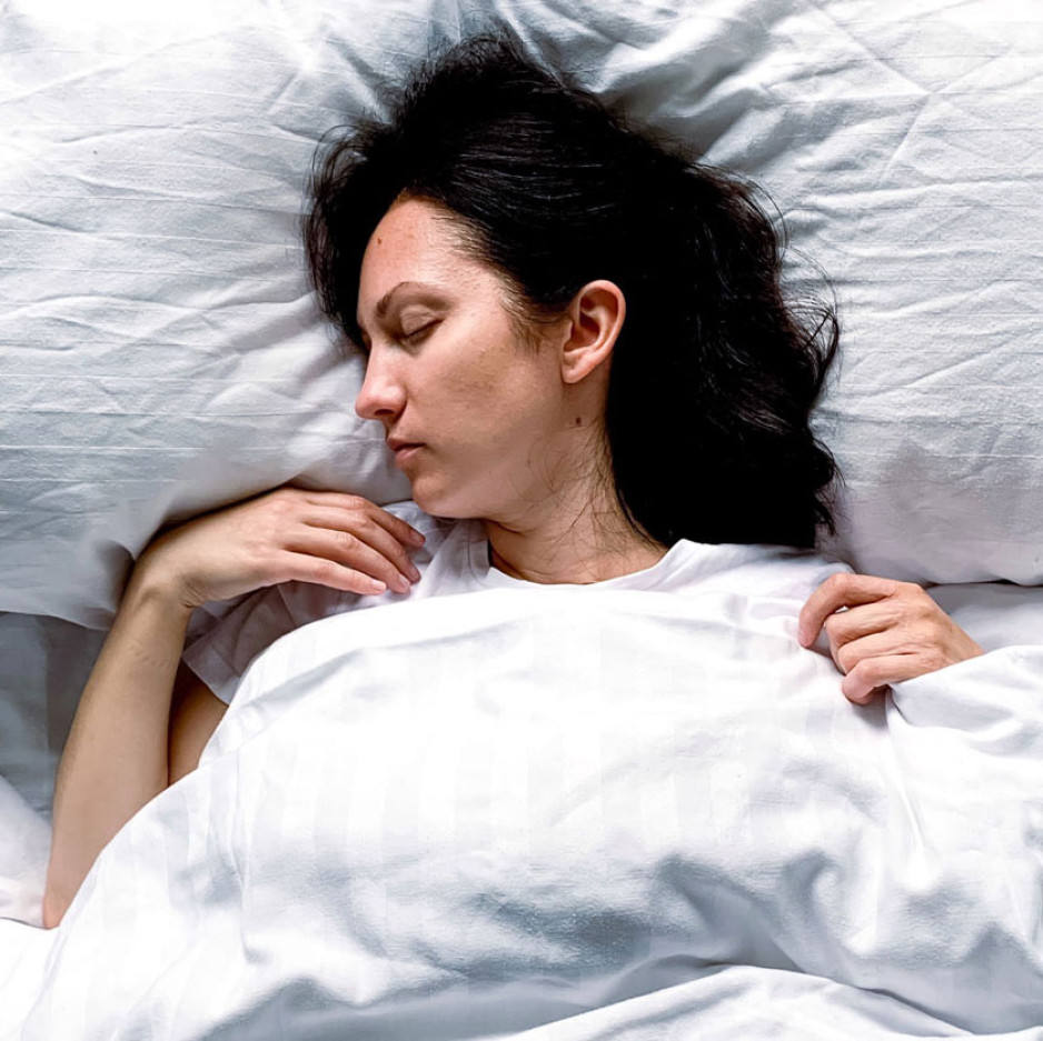 a young woman asleep in her bed